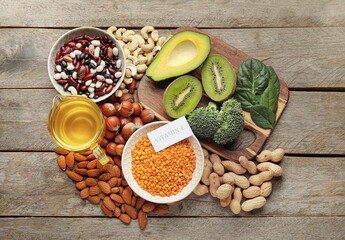 Healthy products rich in vitamin E on wooden background