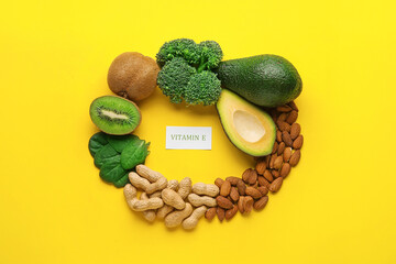 Frame made of healthy products rich in vitamin E on color background