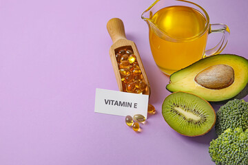 Fototapeta na wymiar Healthy products rich in vitamin E and fish oil capsules on color background, closeup