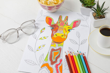 Coloring picture, glasses, cup of coffee and pencils on wooden background
