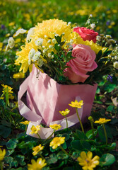 Beautiful bouquet on blurred background. Romantic gift. Flowers in a basket. Roses and chrysanthemums. Yellow marigold.