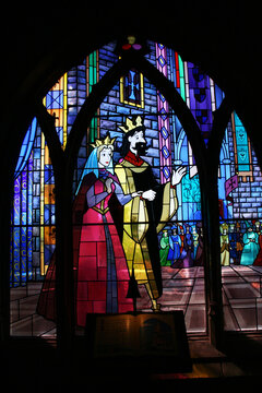 Stained glass window with Sleeping Beauty's parents. King and Queen from the Disney movie. Book with the story of Sleeping Beauty. Princess Castle at Euro Disney. Disneyland Paris. The magic of Disney