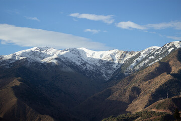 snow topped mountains with clear blue sky and clouds in the High Atlas mountains