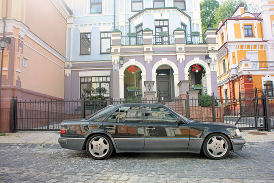 Kiev, Ukraine - 25 August 2014: Gray Mercedes E500 W124 Wolf on the background of beautiful old houses