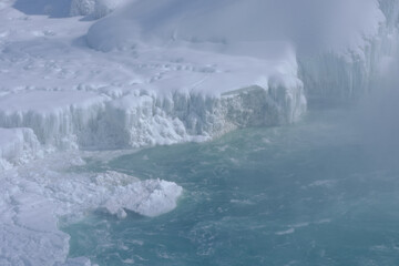 Fototapeta na wymiar Ice buildup at the base of Niagara Falls 
