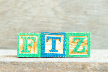Color alphabet letter block in word FTZ (Abbreviation of Free trade zone) on wood background