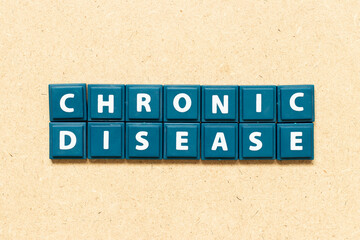 Tile alphabet letter in word chronic disease on wood background