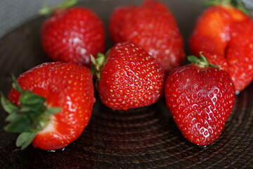 strawberries on a wooden table. strawberries in a bowl. 