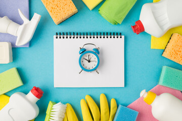 Above photo of equipment for cleaning and notebook with alarm clock in the middle isolated on the...