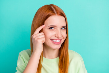 Photo of cheerful young positive woman point finger head think smile isolated on pastel teal color...