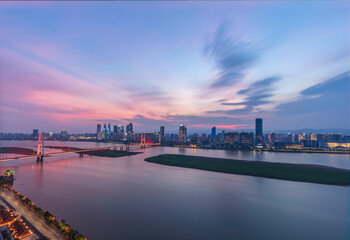 The aerial view of the city is located on both sides of the Ganjiang River. The Bayi Bridge crosses the river and forms a magnificent view against the surrounding buildings. Nanchang City, China.