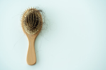 Used dirty hair brush left on the table with copyspace.
