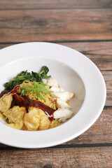 Shrimp dumpling noodles and crab meat on wood background
