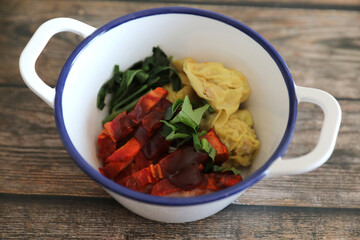 Shrimp dumpling with roasted pork on wood background