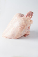 raw chicken breast with skin, white background