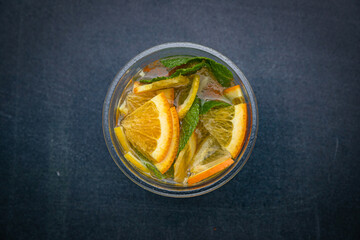 Lemonade with lemon, mint on a dark table
