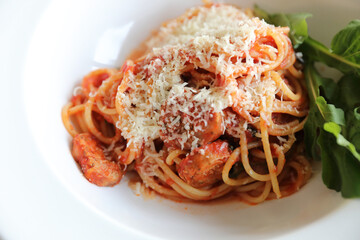 spaghetti Bolognese with italian sausage and tomato sauce with parmesan cheese and basil