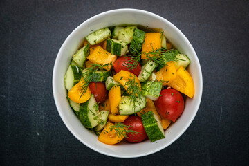 Delicious salads on a dark table
