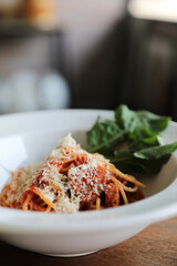 spaghetti Bolognese with italian sausage and tomato sauce with parmesan cheese and basil