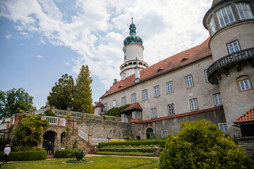 Baroque romantic castle Nove mesto nad Metuji with park, renaissance chateau, round white clock tower, red tile roof, Italian garden, summer sunny day, Eastern Bohemia, Czech Republic