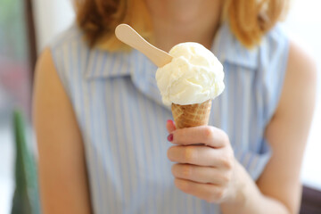 Woman hand with ice cream in close up