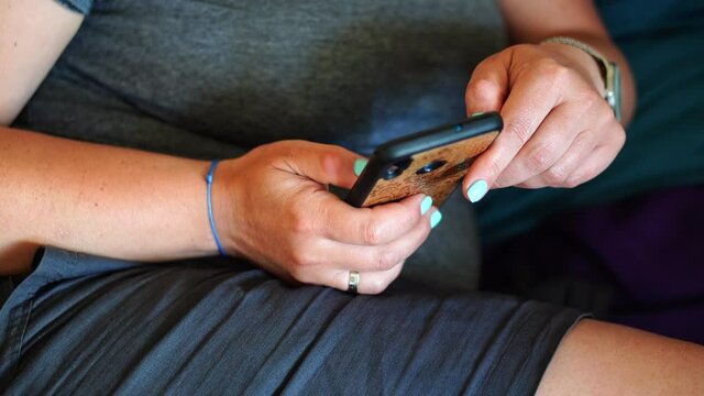POZNAN, POLAND - Jun 16, 2021: Person using a smartphone with a protection cover