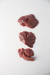 Raw chicken liver, white background, 3 pieces
