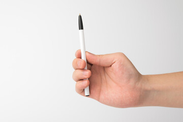 hand holding a pen on a white background