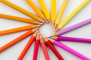 colored wooden pencils on a white background