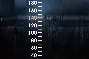 Waterline of the black barge hull with immersion depth markings.