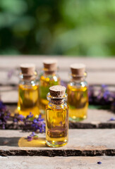 essential oil bottles with fresh sage on the nature blurred background

