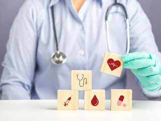 Hand of doctor arranging wood blocks with healthcare medical icons. Space for text. Health and...