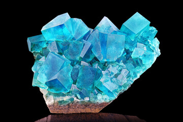 Amazing colorful macro closeup of aqua blue rare fluorite mineral specimen isolated on black...