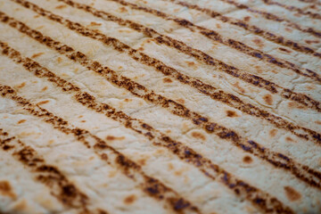 close up texture pita bread with stripes side view. healthy food