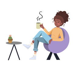 Girl is enjoying her break with coffee, sitting in a comfortable chair 