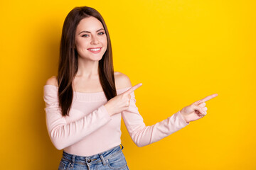 Fototapeta na wymiar Photo of young smiling cheerful girl point fingers copyspace advertising product isolated on yellow color background