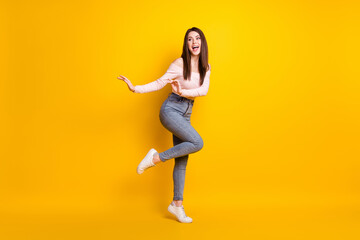 Fototapeta na wymiar Full size photo of young funky funny smiling woman look copyspace dreaming dancing isolated on yellow color background