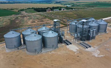 New industrial grain silos grain storage tanks from drone, aerial view 