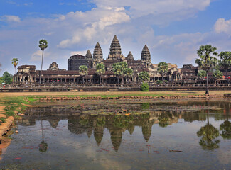 The temple of Angkor Wat, reflected in a lake, the world's largest religious monument, near Siem Reap, Cambodia.