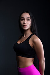 Obraz premium portrait of a young woman in the studio on a dark background 