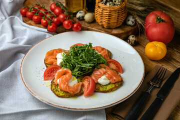 Salmon, cheese, tomatoes on croutons on a wooden table
