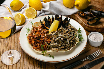 Seafood with lemons on a wooden table
