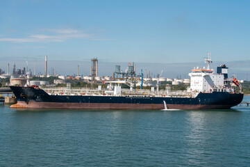 UK. 2021. An oil/chemical tanker ship alongside and berthed at a refinery,