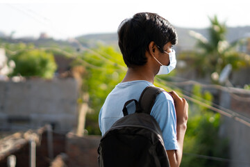 Portrait of an Indian kid wearing mask going to school, New normal in schools	