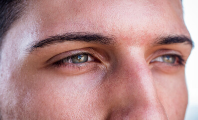 Naklejka premium Close-up of green eyes of a handsome young man