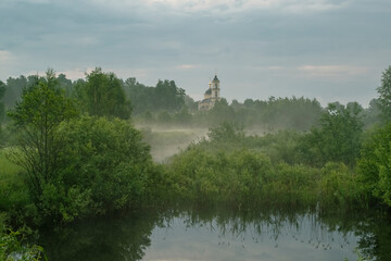 Fototapeta na wymiar Temple of the Bright Resurrection of Christ. Orthodox Christianity. Early morning, fog, lake. Vladimir region, Russia