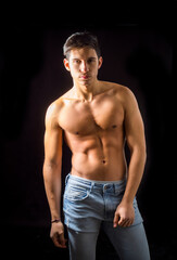 Fototapeta na wymiar Handsome muscular shirtless young man standing confident