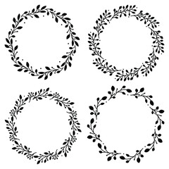 Set of 4 hand drawn spring wreaths isolated on white background, vector. Silhouette circle of leaves. Doodle style.Collection of floral frames.