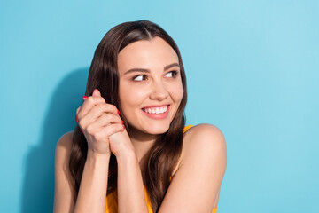 Fototapeta premium Photo portrait girl keeping hands together smiling cute looking blank space isolated pastel blue color background