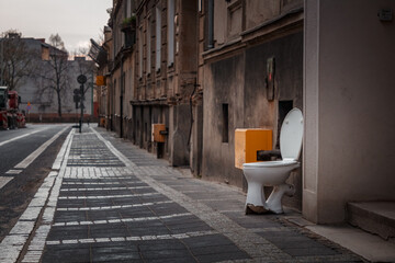 toilet standing in the middle of an old European street - Powered by Adobe